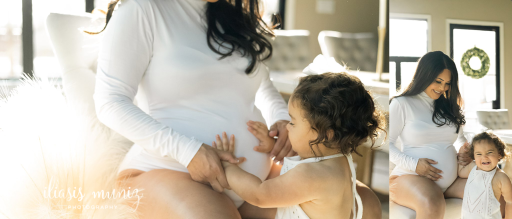 baby touching belly